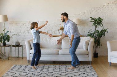 Mutlu genç baba genç oğlanla dans ediyor.