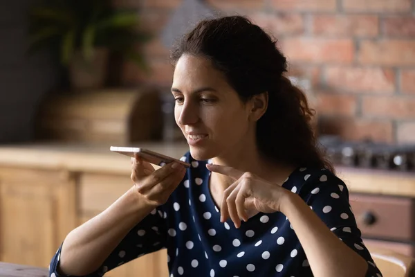 Pleasant happy young latin woman sending voicemail. — Stock Photo, Image