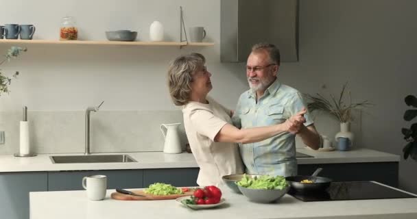 Romantic senior adult family couple dancing tango waltz at kitchen — Vídeo de Stock