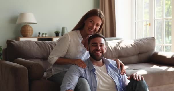 Portrait of romantic loving spouses relaxing at modern living room — Stockvideo