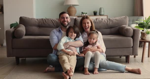 Parents with kids daughter son sit on floor bonding smiling — Video Stock