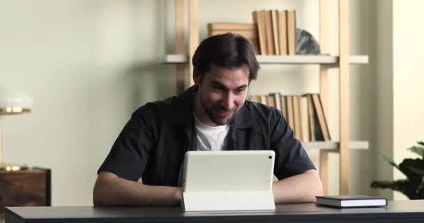 Millennial guy take part in videoconference use digital tablet — Vídeo de Stock
