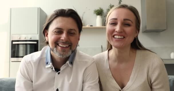 Attractive happy couple participate in virtual meeting at home — Stockvideo