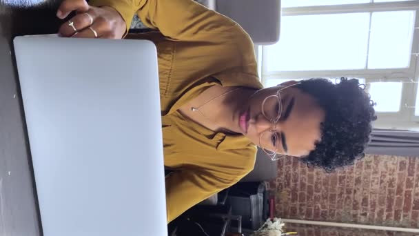 Pensive thoughtful African woman sit at desk working on laptop — Stockvideo