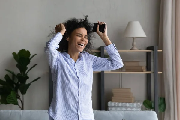 Happy young african woman celebrating online lottery win. — Stock Photo, Image