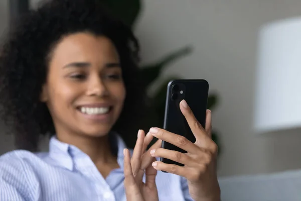 Feliz millennial africana mujer usando el teléfono celular en casa. — Foto de Stock