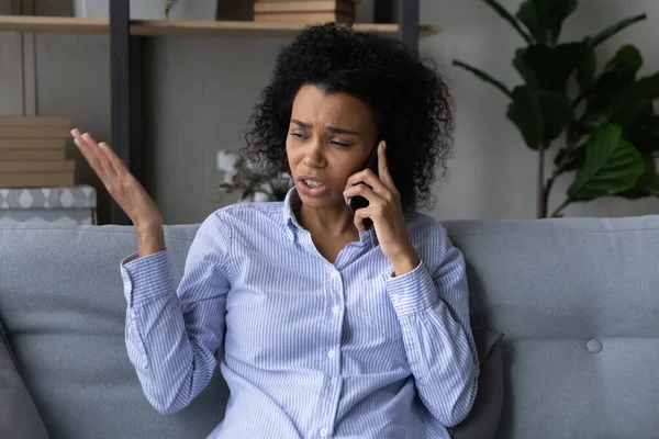 Unhappy millennial african woman holding unpleasant conversation. — Stockfoto