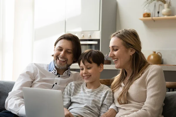 Happy 40s family couple and teenage kid resting on couch — ストック写真