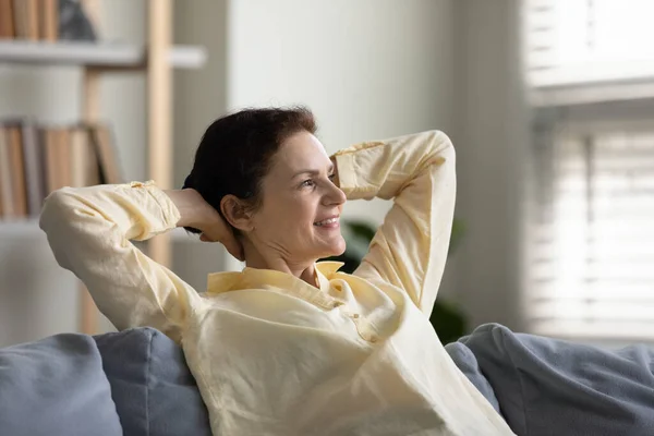 Happy old woman resting on sofa at home. — Foto Stock