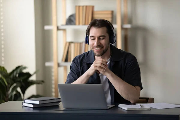Happy young man in headphones communicating by video call. — Stock Photo, Image