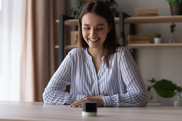 Happy young woman using small portable speaker — Fotografia de Stock