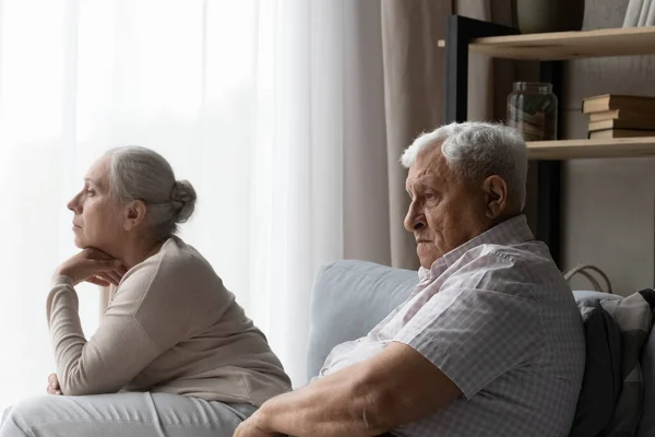 Frustrated unhappy old family couple feeling depressed at home. — Stockfoto