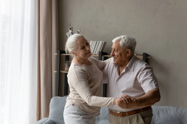 Happy bonding old retired family couple dancing at home. — Stock Fotó