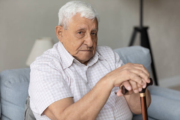 Unhappy pensive old man looking in distance.