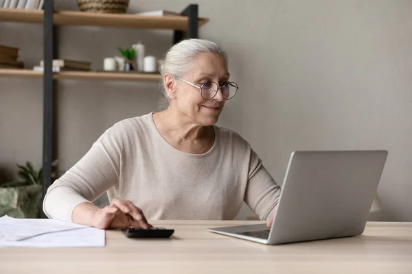 Happy older retired woman planning monthly budget. — Stock Photo, Image