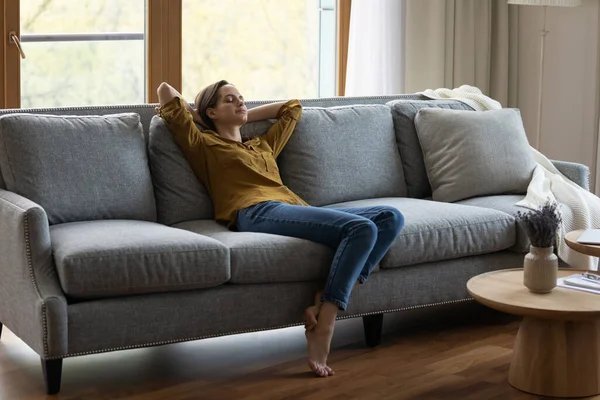 Peaceful relaxed tenant, renter girl enjoying leisure at home — 图库照片