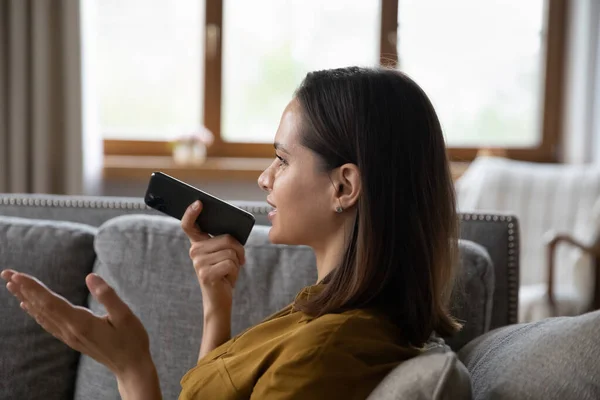 Happy satisfied cellphone user woman recording audio message — Stockfoto