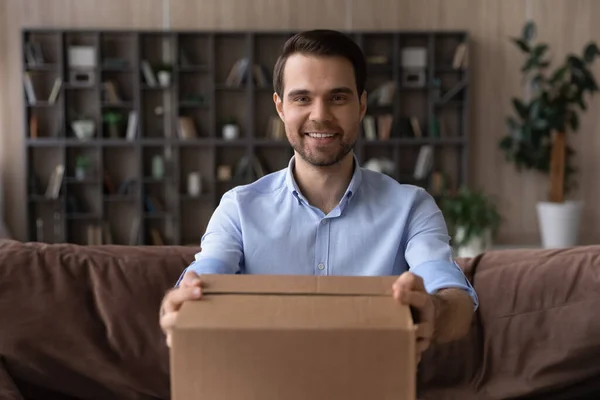 Head shot portrait smiling man holding cardboard box, received parcel — Zdjęcie stockowe