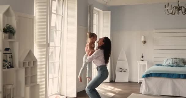 Happy mother holds throws up her cute preschool daughter — Wideo stockowe