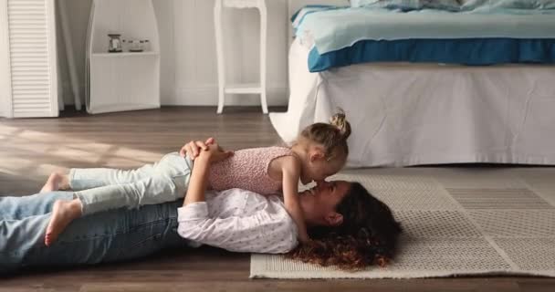 Young affectionate mother touch noses play with little 4s daughter — Vídeos de Stock