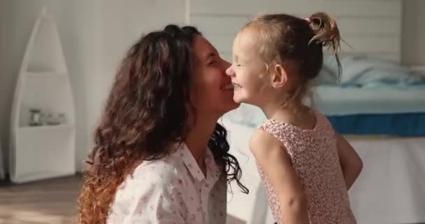 Preschool daughter her mom touch noses laughing play at home — Vídeos de Stock