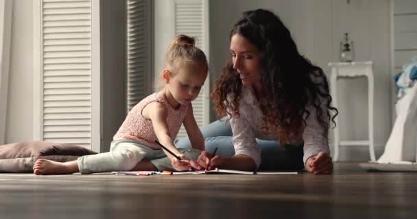 Hispanic woman her daughter drawing in album giving high five — Stockvideo