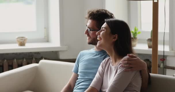 Couple daydreaming, relaxing on sofa looking into distance — Vídeo de Stock