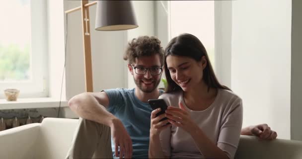 Couple look at cellphone screen scream with joy celebrate success — Video