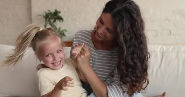 Close up of happy cheerful mom tickle her adorable daughter — Video Stock
