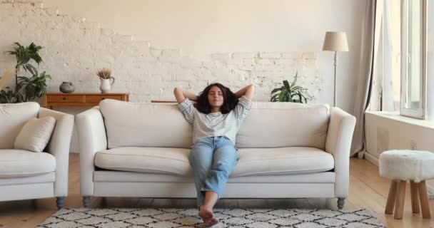 Serene calm Latina woman relaxing on sofa at home — стокове відео