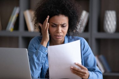 Concerned frustrated African worker in casual getting document