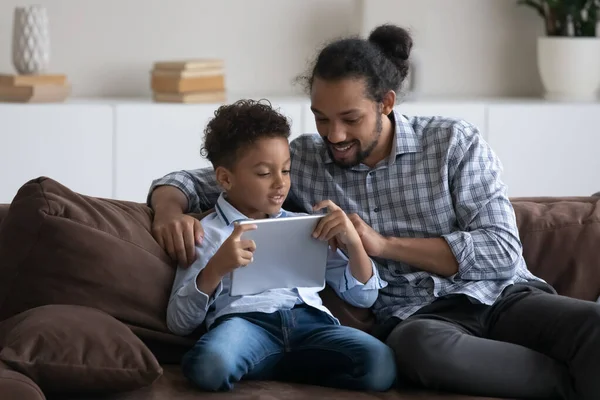 Happy gen Z son kid and dad using online app — Photo