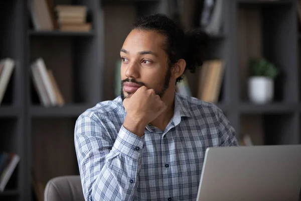 Thoughtful pensive Black freelance employee guy working at laptop — Fotografia de Stock