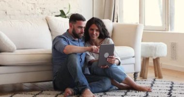 Happy couple using digital tablet have fun on internet
