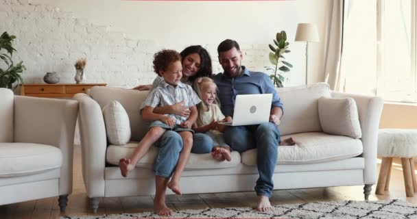 Beautiful family enjoy e-shopping sit on sofa with laptop — стоковое видео