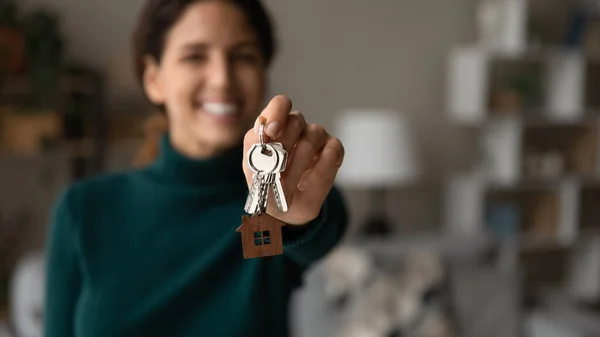 Young happy blurred woman showing keys to camera. — Stockfoto