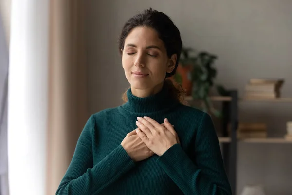 Peaceful young woman feeling thankful at home. — Stock Photo, Image