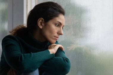 Stressed young hispanic woman suffering from negative thoughts.