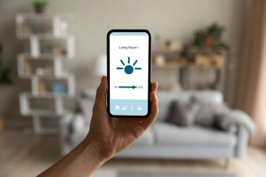 Close up cellphone with smart home application on screen.