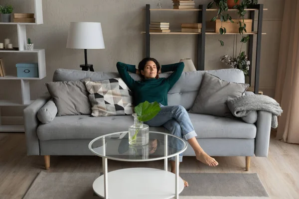 Relaxed young woman napping on comfortable sofa. – stockfoto
