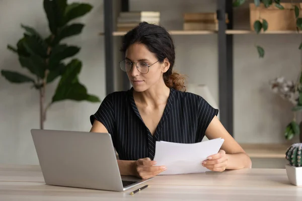 Concentrated smart young worker analyzing paper document. — Foto de Stock