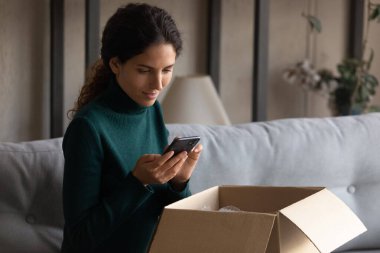 Beautiful millennial client typing review for internet service.