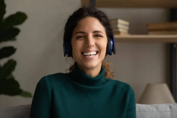 Happy millennial hispanic woman in headphones holding video call conversation. — Photo