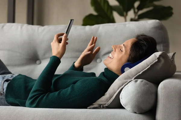 Happy relaxed young woman holding distant video call conversation. — ストック写真