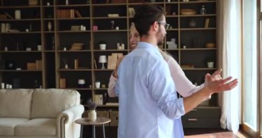 Older woman dance waltz with grown up son at home