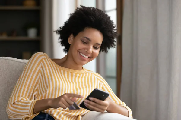 Smiling millennial African American relaxed woman shopping online. — Stock Photo, Image