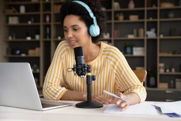 Concentrated African American female radio program host working in office. — Stock Photo, Image