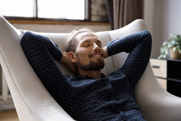 Smiling sincere handsome young man resting at home. — Foto Stock