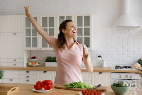 Happy young woman having fun, cooking in modern kitchen. —  Fotos de Stock