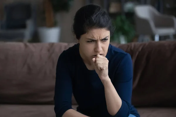 Unhealthy young Indian woman coughing at home. — Zdjęcie stockowe